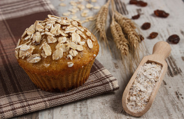 Fresh muffin with oatmeal, rye flour and ears of rye grain, delicious healthy dessert