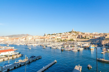 Fototapeta na wymiar Marseille. Boats in the Old Port, the Basilica of Notre-Dame de la Garde in the background