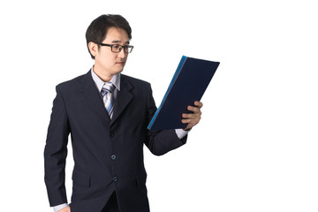 Asian businessman reading important information in file folder,