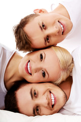 Happy friends together- one woman and two men