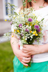 Woman holding wild flowers