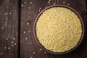 hulled millet on a dark background