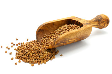 Buckwheat grains in wooden scoop