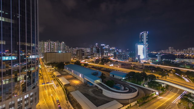 Top view of busy traffic night in finance urban timelapse hyperlapse with panorama of city buildings, hong kong city