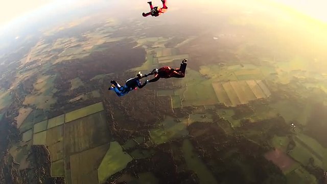 Team of Skydivers jump from the Airplane