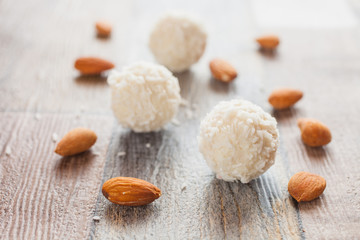 coconut balls and kernels of almonds on a table, selective focus