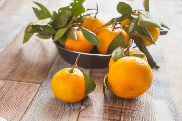 tangerines with leaves on a table, selective focus