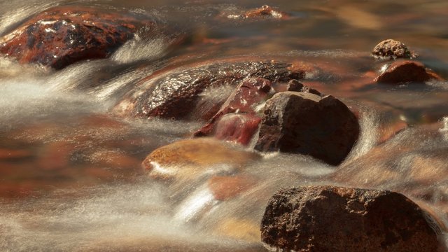 River Rocks - Time lapse of Sierra snow melt flowing over river rocks.