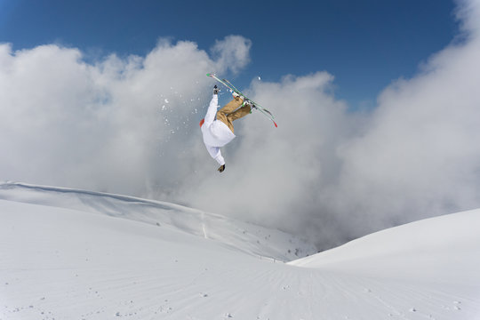 Flying skier on mountains. Extreme sport.