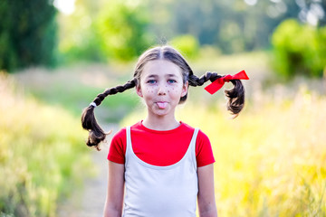 girl with pigtails imagines the summer on the nature
