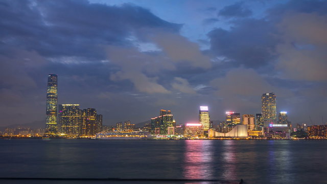 Shyline panorama timelapse day to night with International Commerce Centre in West Kowloon, Hong Kong.
