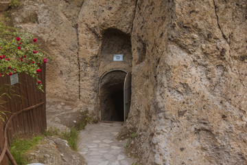Fototapeta na wymiar Entrance of old way indise rocky mountain excavated by Old Ottomans during war to hide them families
