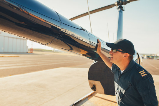 Mechanic checking helicopter before take off.