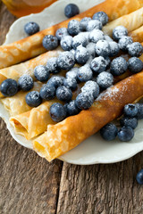 pancakes with blueberries on wooden surface