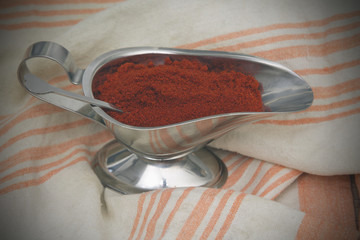 jar with paprika on napkin