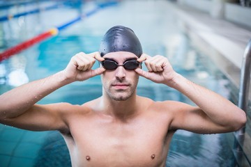 Handsome man wearing swim cap and goggles