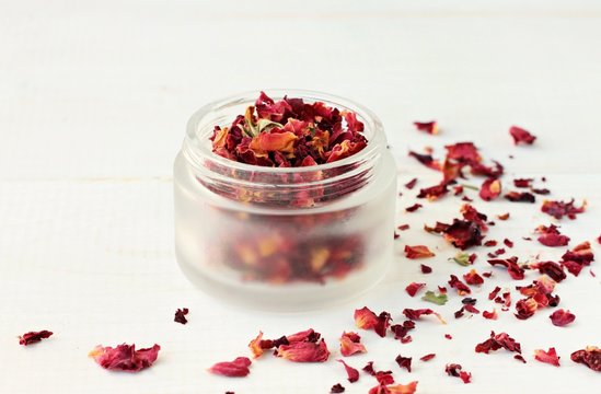 Fragrant dried rose petals in cosmetic jar. Herbal therapy. 
