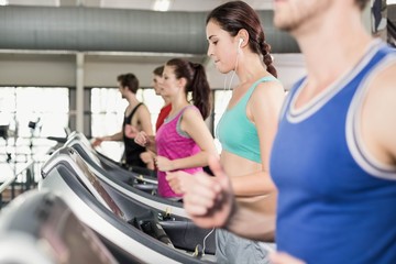 Fototapeta na wymiar Women and men running on a treadmill