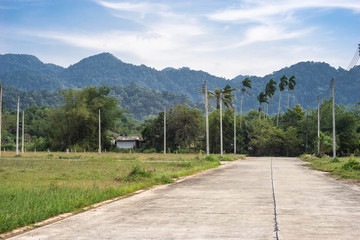 cement road and  electricity post, hil background