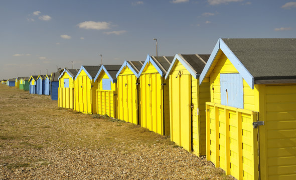 Yellow beach huts,England.