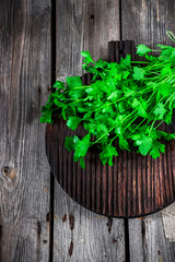 Parsley  on dark cutting board.