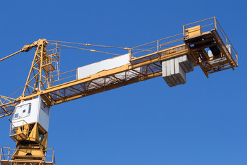 Construction crane on a blue sky background.