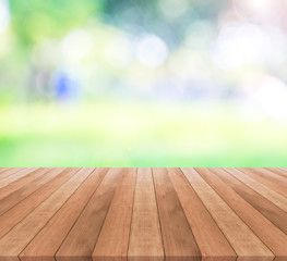 Naklejka na ściany i meble Wooden table top on blurred green background - used for display your products
