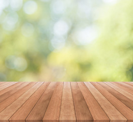 Naklejka na ściany i meble Wooden table top on blurred green background - used for display your products