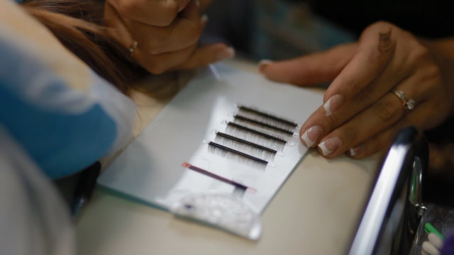 Female lashmaker work on tablet