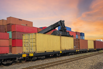 forklift handling and train  with container in shipyard for Logistic Import Export background  at sunset