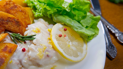 Lemon baked Haddock with fried Popapoes. Lemon sause,