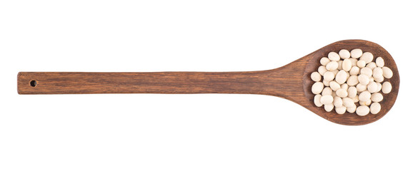 Close up of dry white beans on wooden spoon on white background