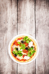 Vegetarian Pizza with vegetables on rustic wooden table top view image
