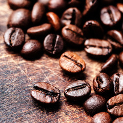 Coffee beans on grunge wooden background