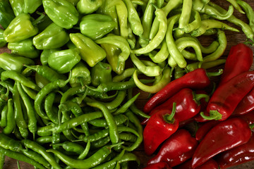 many red and green peppers on a kitchen bench.
