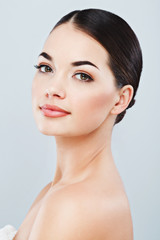 Obraz premium Gorgeous girl with dark hair at gray studio background