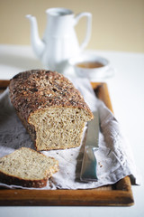 Fresh loaf of sourdough bread with many seeds, whole wheat