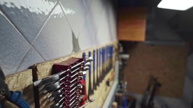 A lot of instruments on mechanic's toolbar in bicycle's workshop. Slider shoot