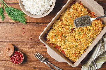 Oven-roasted fish fillet with carrots under a bread crust