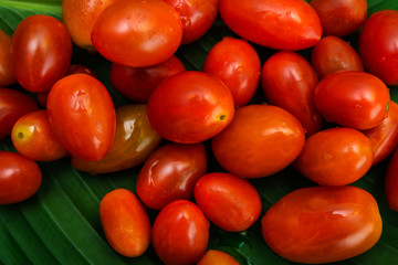 Small red cherry tomatoes  on an green leaf