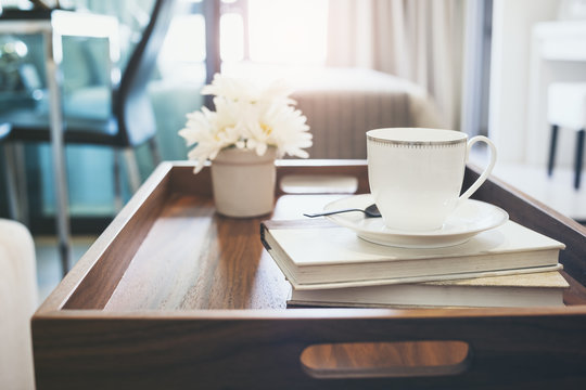 Home Interior with Coffee cup Book white flower on table wooden