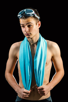Teen swimmer against black background.