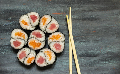 Rolls Yin-Yang with tuna and salmon on gray blue background