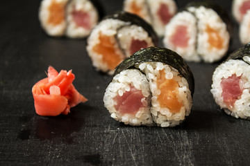 Rolls Yin-Yang with tuna and salmon on a black background