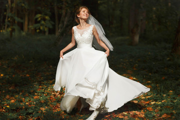 luxury stylish young bride on the background  spring sunny green