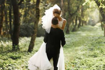 luxury stylish young bride and groom on the background  spring s