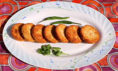 Aloo Tikki or Fried Potato Patties; a popular Indian snack served with tomato and chilli sauce.