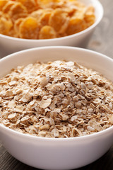 Oatmeal and cornflakes in white ceramic bowl