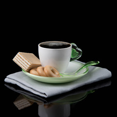 white Cup of coffee and waffles isolated on dark background