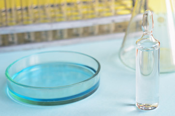 Chemical research in Petri dishes. Vaccine ampoule. Medicament.